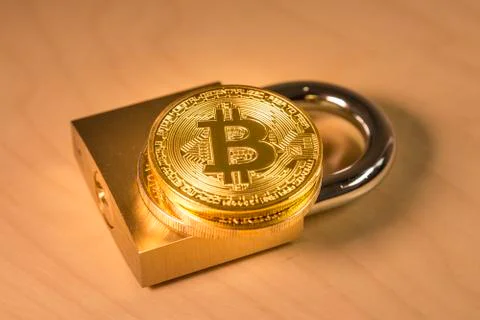 Bitcoin over a padlock Stock Photos