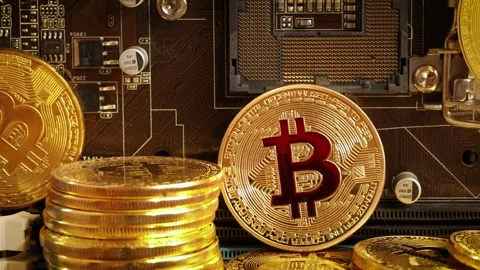 Bitcoin physical coins resting on computer motherboard circuit board in hig.. Stock Footage 337344220