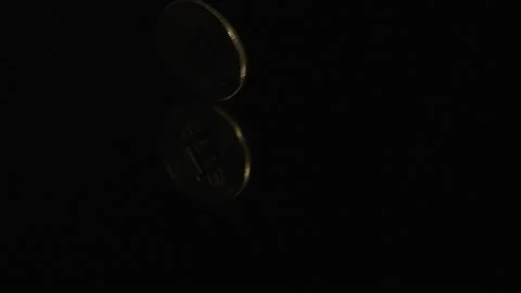 Bitcoin in physical currency rotating on a black background Stock Footage 154455512