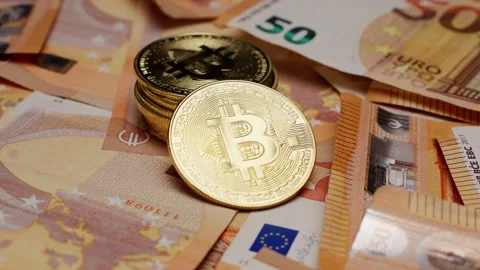 Bitcoin placed on euro banknotes representing financial contrast and change Stock Footage 312030877