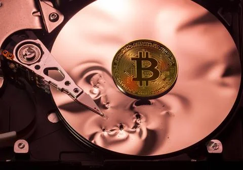 Bitcoin price collapse concept using hard drive Bitcoin superimposed on th... Stock-Fotos