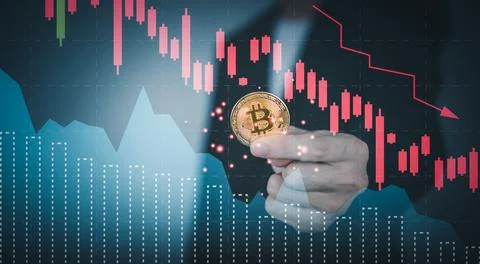 Bitcoin price crash falling down with graph. Man hand holding cryptocurrenc.. Stock Photos