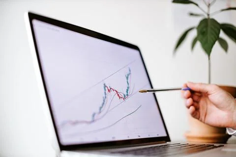 Bitcoin price graph data trend analysis on laptop screen Stock Photos