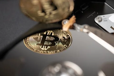 Bitcoin reflection on hard drive disk Stock Photos