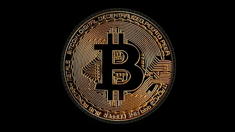 A Bitcoin rendering rotating seamlessly against a black background - loopable. Stock Footage 128812093
