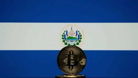 Bitcoin representation coin placed in front of blurred Salvador's national flag. Stock Footage 155462647