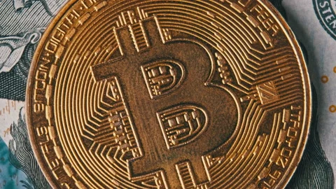 Bitcoin Rotates in Macro Against the Background of Dollars Stock Footage 236789008