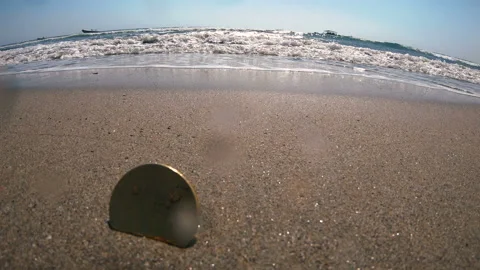 Bitcoin On the sand lies Bitcoin on the background of the blue sea Video stock 107178053