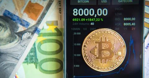 Bitcoin on the schedule of course change in the program on a mobile phone (In Stock Photos