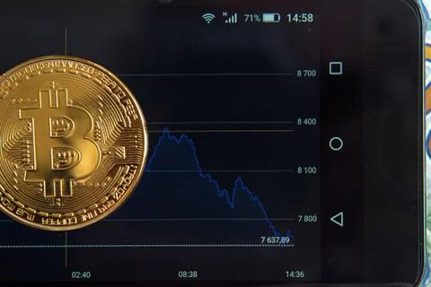 Bitcoin on the schedule of course change in the program on a mobile phone (In Stock Photos