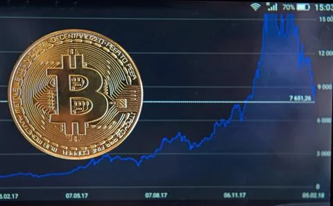 Bitcoin on the schedule of course change in the program on a mobile phone (In Stock Photos