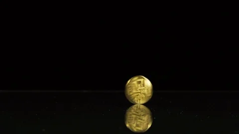 Bitcoin spin on a black mirror table Stock Footage 92760866