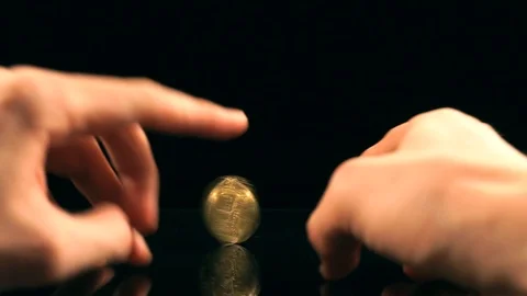 Bitcoin spin on a black mirror table Stock Footage 100332126