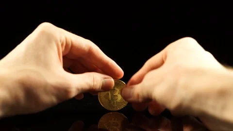 Bitcoin spin on a black mirror table Stock Footage 100332128