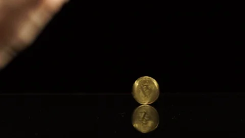 Bitcoin spin on a black mirror table Stock Footage 100332143