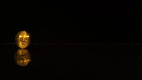 Bitcoin spin on a black mirror table Stock Footage 100332238