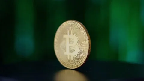 Bitcoin spinning around 360 with code in the background Stock Footage 231742885