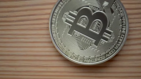 Bitcoin spinning Coin Placed on a Wooden Surface, Digital Ass et Revolution Stock Footage 293607024