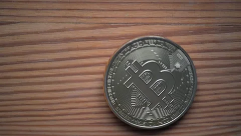 Bitcoin spinning Coin Placed on a Wooden Surface, Digital Ass et Revolution Stock Footage 293607089