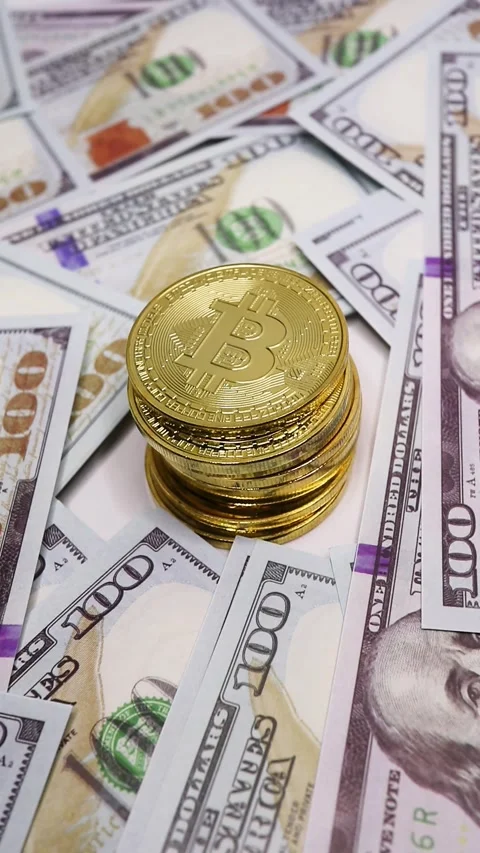 Bitcoin on Stack of Dollar Bills. Video stock 289434744