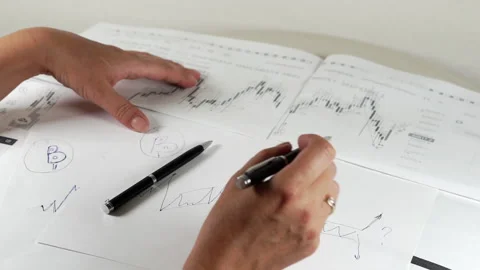 Bitcoin Stock Chart Analysis: A broker, trader or investor is analyzing a Stock Footage 159438419