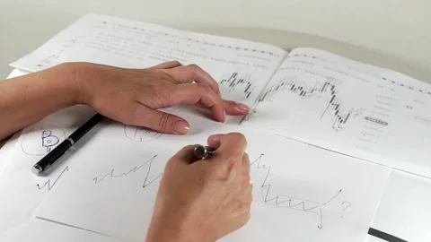 Bitcoin Stock Chart Analysis: A broker, trader or investor is analyzing a Stock Footage 159961850