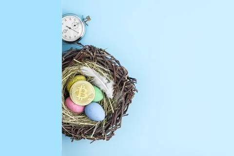 Bitcoin, stopwatch, easter eggs and nest flatlay. Stock Photos