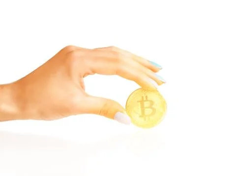 Bitcoin - symbol of cryptocurrency in a hand. Stock Photos
