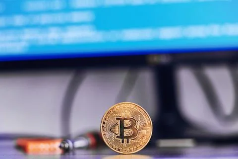 Bitcoin on a table with code on background Foto stock