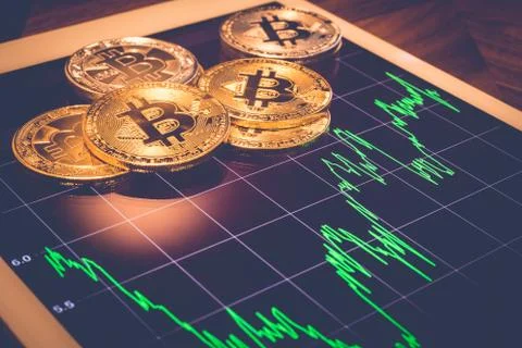 Bitcoin on tablet with market performance graph, vintage. Stock Photos