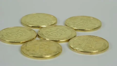 Bitcoin token, token with the bitcoin logo is spinning on a white background. Stock Footage 159055820