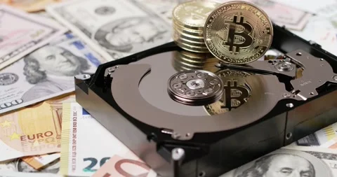 Bitcoin on top of Hard Disk, BTC coin reflecting on platter. Dollar and Euro Video stock 154055874