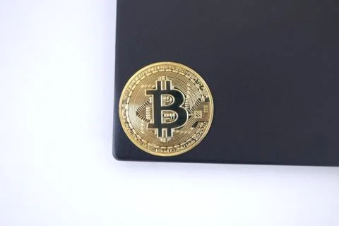 Bitcoin on the top of laptop Stock Photos