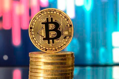 Bitcoin on top of Money stack, against blurry background.Bitcoin on top of Mo Stock Photos