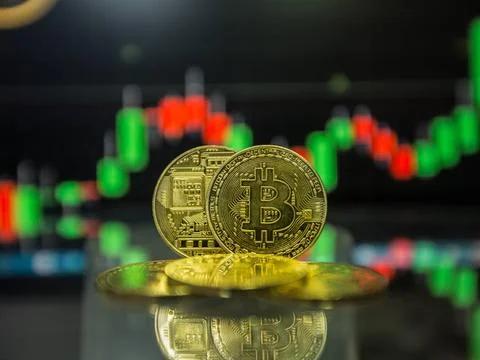 Bitcoin on top of Money stack, against blurry background Golden bitcoin ar... Stock Photos