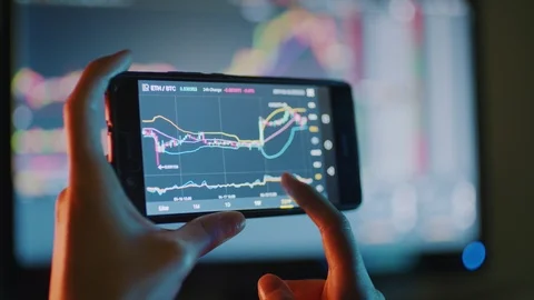 Bitcoin trading on a smart phone Video stock 107086260