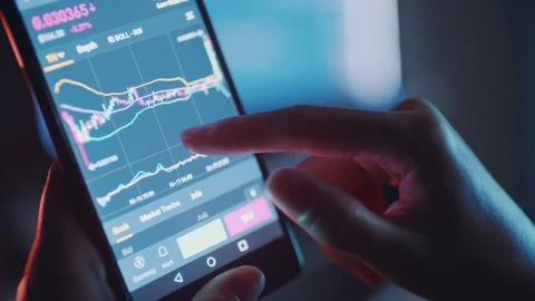 Bitcoin trading on a smart phone Video stock 107086863