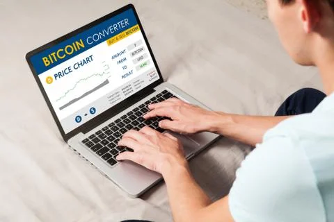 Bitcoin trading website. Man using a laptop to trade bitcoin price Stock Photos