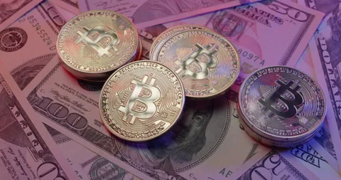 Bitcoin on US Dollar banknotes. Rotating crypto and fiat currency Stock Footage 176562588