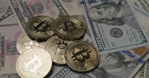 Bitcoin on US Dollar banknotes, rotating bills with coins on top. Stock Footage 176930832