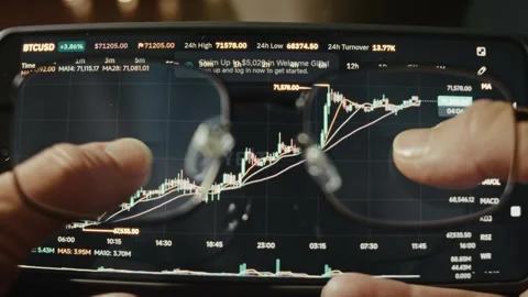 Bitcoin to USD growing price viewed on chart on smartphone through vision Video stock 291451436