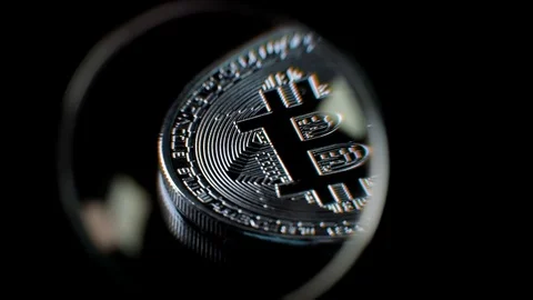 Bitcoin viewed through a magnifying glass Stock Footage 83347721