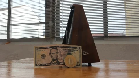 Bitcoin vs dollar value divergence over time. Metronome with btc coin and 5.. Stockbeeldmateriaal 332179158