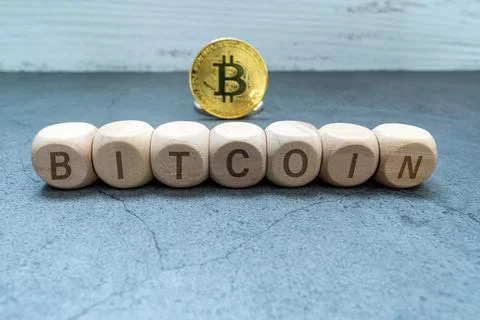 BITCOIN word written on wood block. Bitcoin Gold blockchain hard fork concept Stock Photos