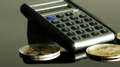 Bitcoins and calculator Stock Footage 86418460
