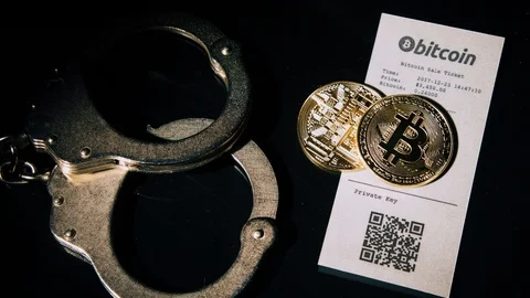 Bitcoins and Handcuff on Black Reflective Ground Stock Footage 119257310