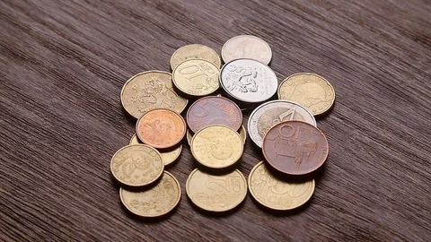 Bitcoins and other coins fall on the table Stock Footage 80201750