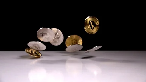 Bitcoins are falling on a black background. Slowmotion shot tossing bitcoin Stock-Footage 115943964