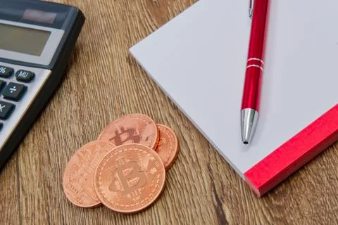 Bitcoins, calculator and notes on a table 스톡 사진