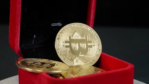 Bitcoins Falling into Rotating Jewelry Box Stock Footage 297269600
